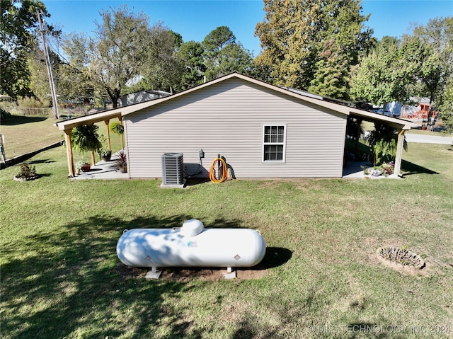 view of home's exterior featuring central AC and a lawn