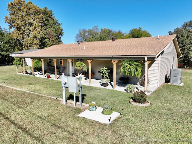 back of property featuring a yard, cooling unit, and a patio