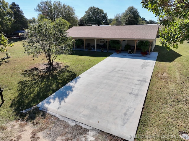 ranch-style house featuring a carport and a front lawn