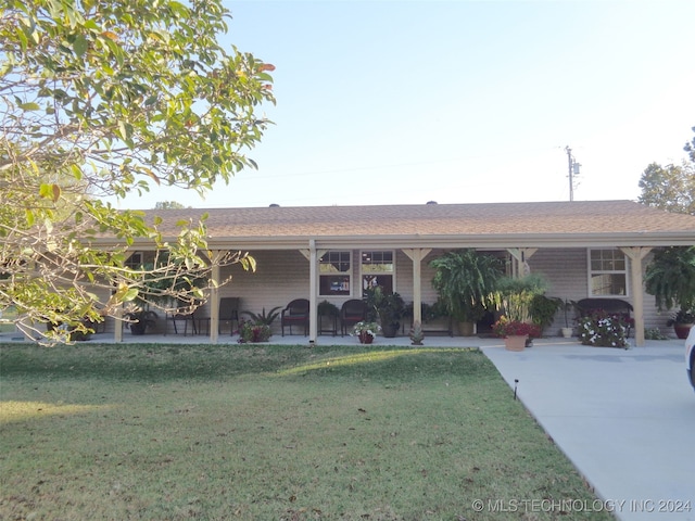 ranch-style house with a carport and a front yard