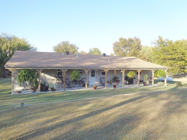 ranch-style home with a patio and a front lawn