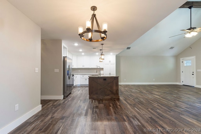 kitchen featuring decorative light fixtures, white cabinets, dark wood-type flooring, stainless steel fridge with ice dispenser, and a kitchen island with sink