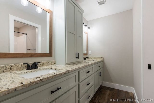 bathroom with vanity and hardwood / wood-style flooring