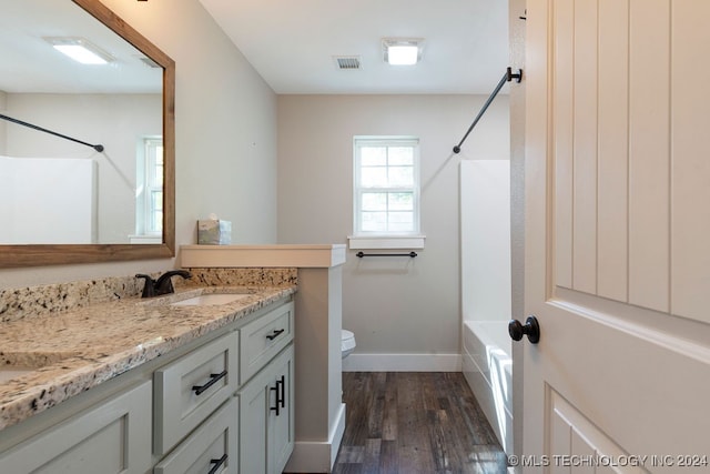 full bathroom with vanity, toilet, bathing tub / shower combination, and hardwood / wood-style floors