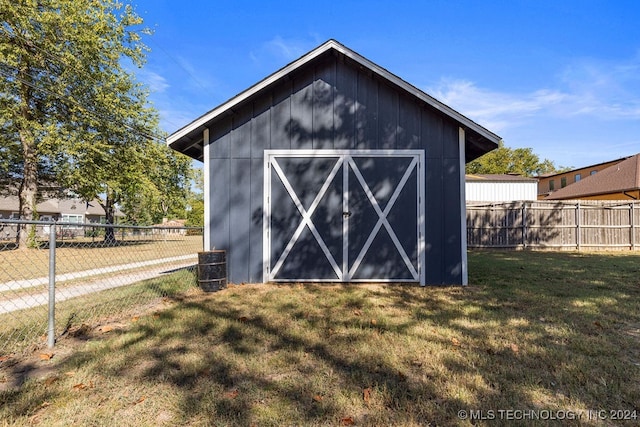 view of outbuilding featuring a lawn