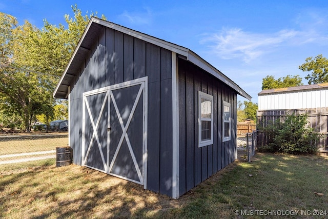 view of outbuilding featuring a lawn