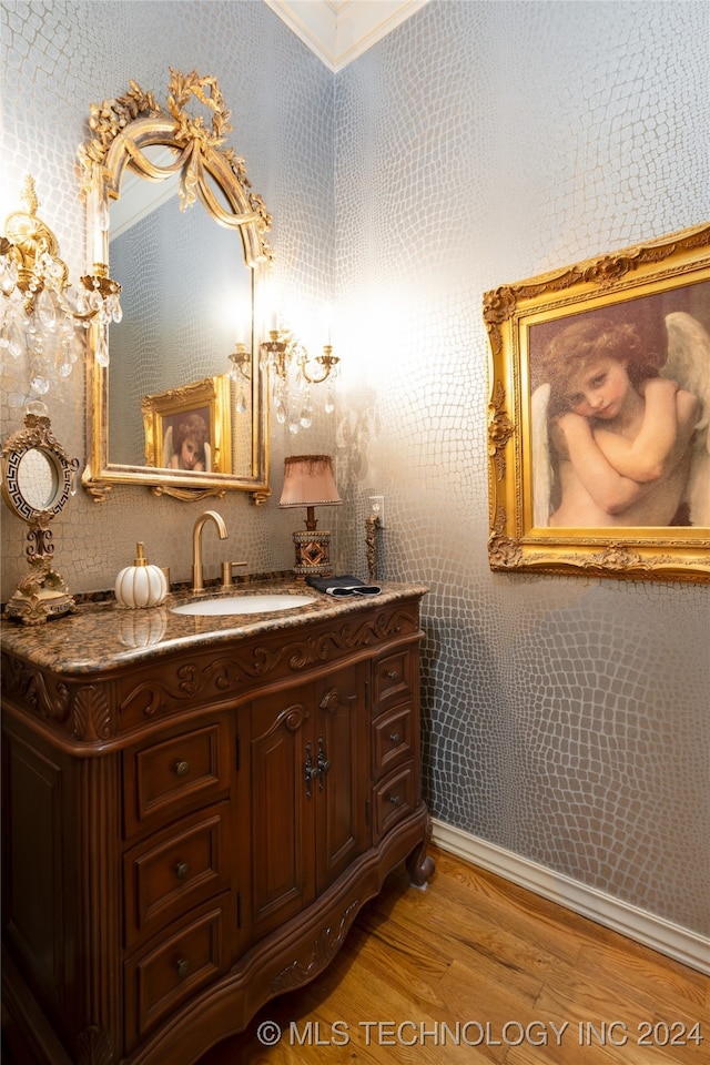 bathroom with vanity, crown molding, and wood-type flooring