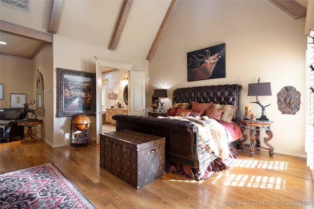 bedroom featuring high vaulted ceiling, ensuite bath, beamed ceiling, and wood-type flooring