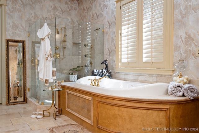 bathroom featuring tile patterned floors and shower with separate bathtub