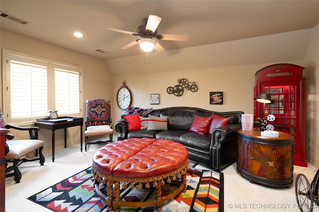 carpeted living room featuring vaulted ceiling and ceiling fan