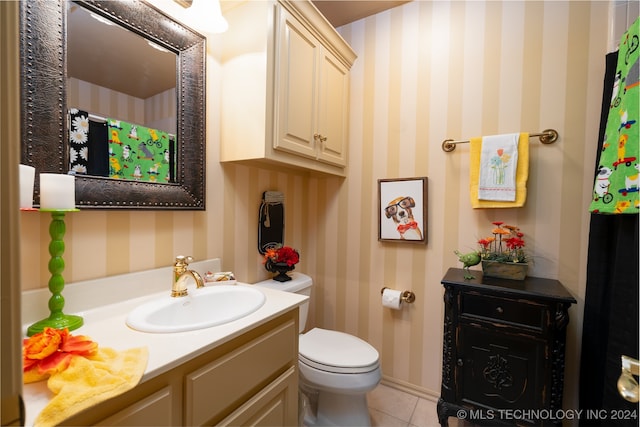 bathroom featuring vanity, toilet, and tile patterned flooring