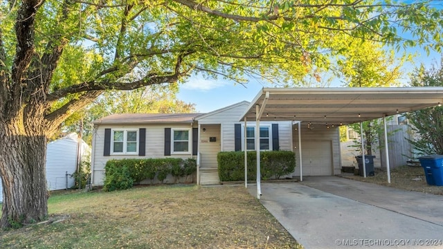 view of front of home with a garage and a carport