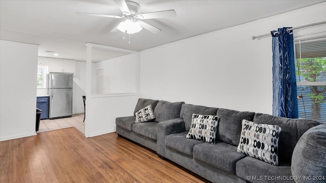 living room with ceiling fan, a healthy amount of sunlight, and light hardwood / wood-style flooring