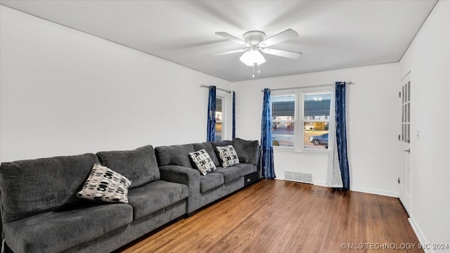 living room featuring hardwood / wood-style flooring and ceiling fan