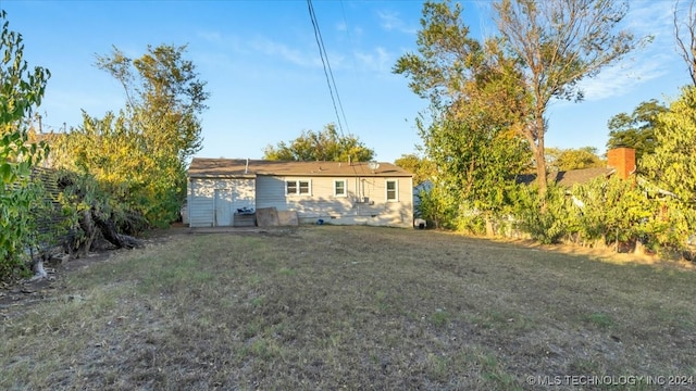 back of house with a lawn