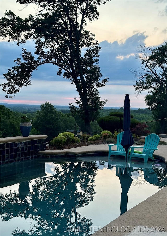 view of pool at dusk