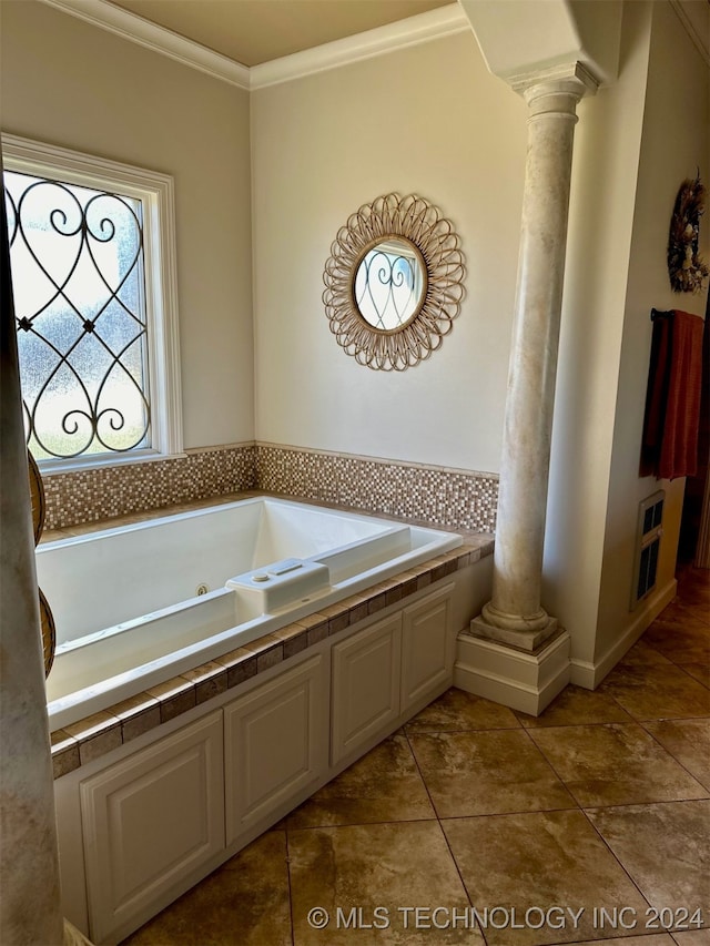 full bath featuring crown molding, a whirlpool tub, tile patterned flooring, and ornate columns