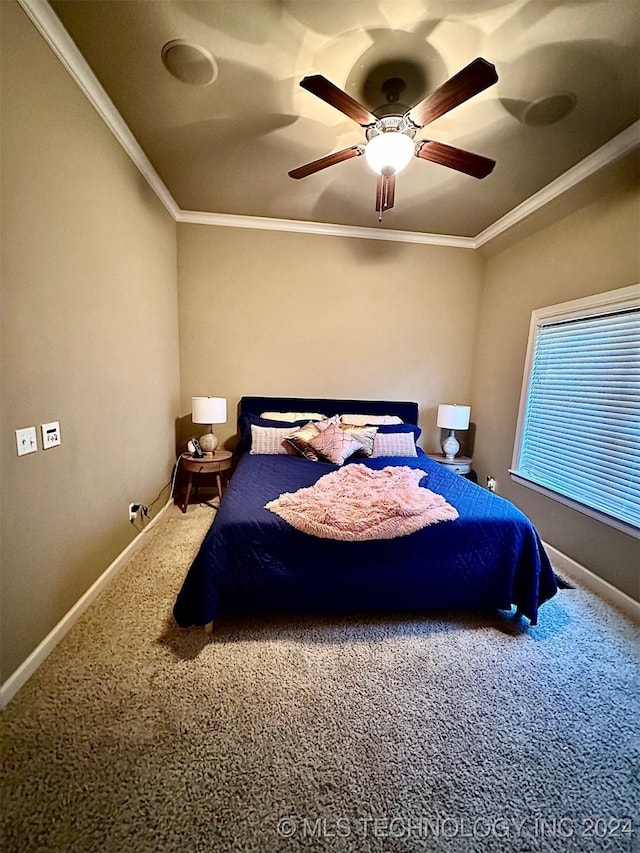 carpeted bedroom featuring baseboards, ornamental molding, and a ceiling fan