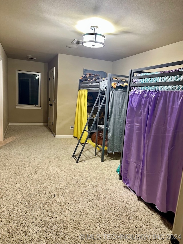 unfurnished bedroom featuring a textured ceiling and baseboards