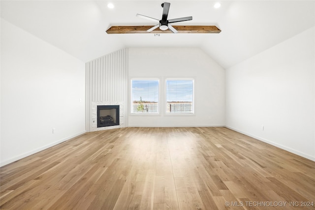 unfurnished living room with light hardwood / wood-style floors, vaulted ceiling with beams, and ceiling fan