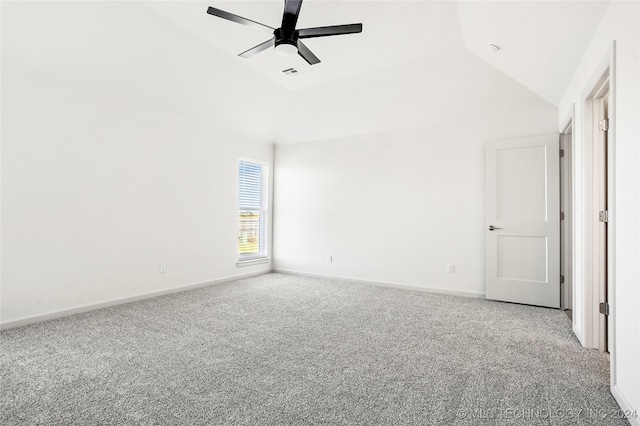 carpeted spare room featuring ceiling fan and high vaulted ceiling