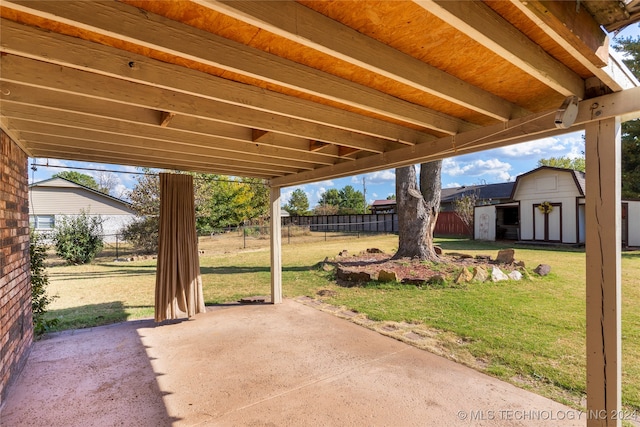 view of patio / terrace featuring a shed, an outdoor structure, and fence