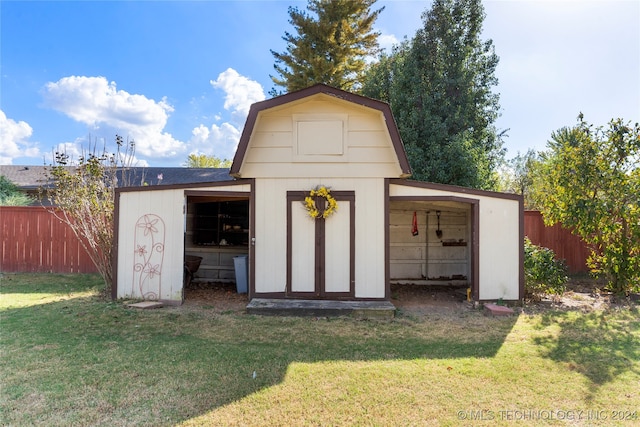 view of outdoor structure featuring an outbuilding and fence