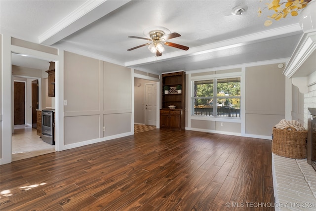 unfurnished living room featuring ceiling fan, a brick fireplace, wood finished floors, and a decorative wall