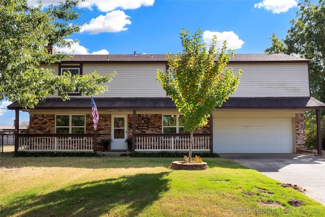 view of front facade with concrete driveway, an attached garage, covered porch, a front lawn, and brick siding