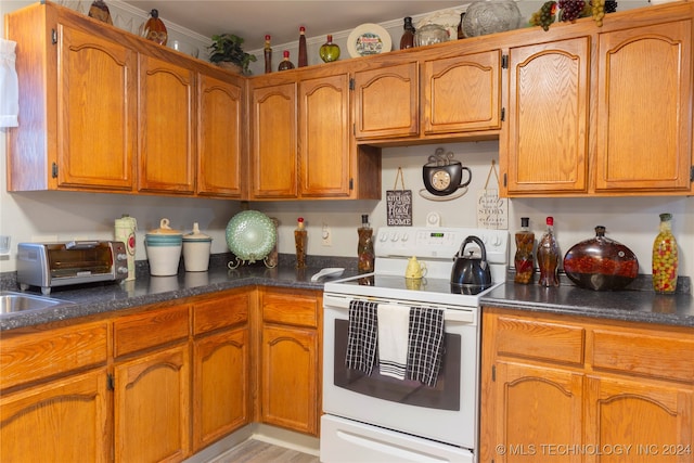 kitchen featuring white electric range and light wood-type flooring