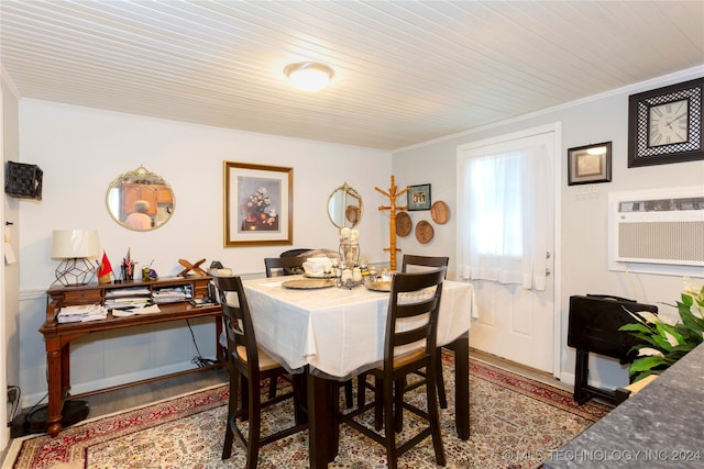 dining area featuring an AC wall unit, crown molding, and wood-type flooring