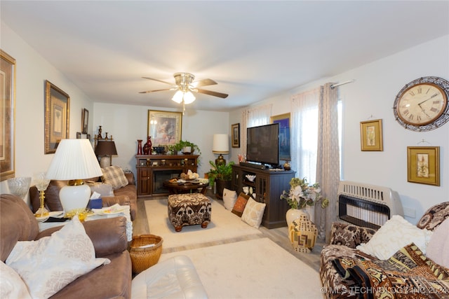 living room with ceiling fan and heating unit