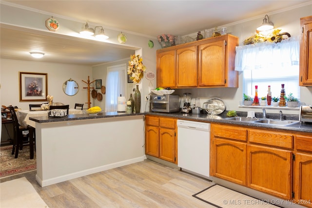 kitchen with dishwasher, kitchen peninsula, sink, crown molding, and light wood-type flooring