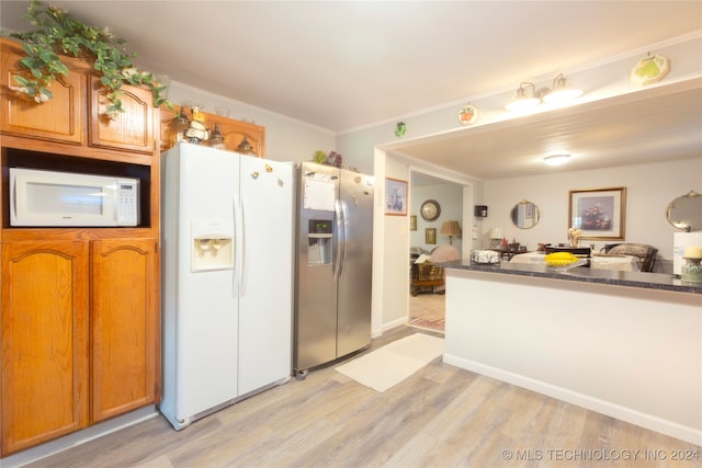 kitchen featuring ornamental molding, light hardwood / wood-style floors, white appliances, and dark stone counters