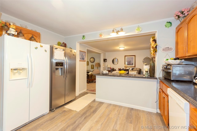 kitchen with white appliances, kitchen peninsula, crown molding, and light wood-type flooring