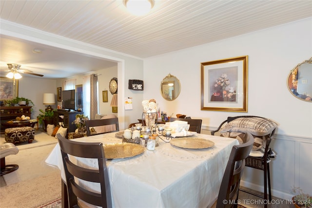 dining space with ornamental molding, carpet flooring, and ceiling fan