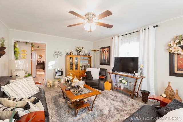 living room with crown molding, wood-type flooring, heating unit, and ceiling fan