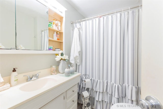 bathroom featuring vanity, toilet, and a shower with shower curtain