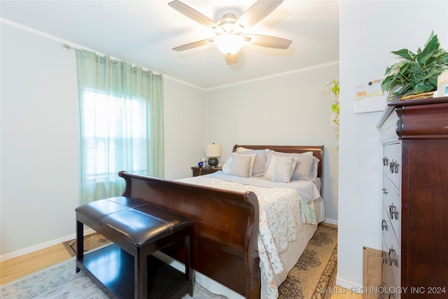 bedroom featuring ceiling fan, crown molding, and light wood-type flooring