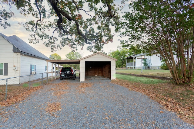 garage at dusk with a carport