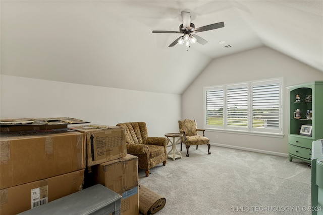 living area featuring vaulted ceiling, light carpet, and ceiling fan