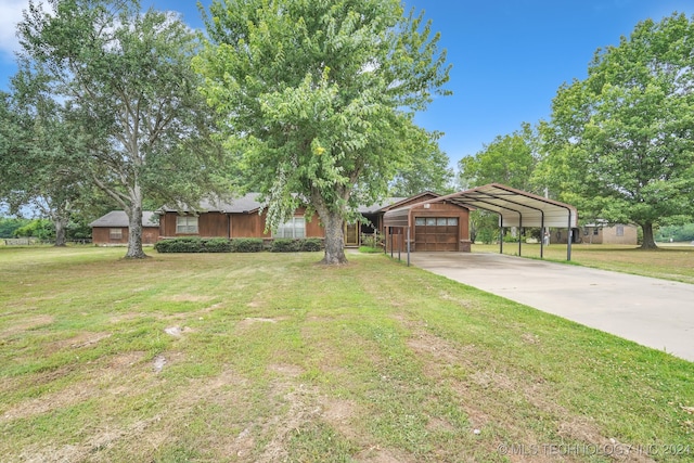 view of yard featuring a garage and a carport