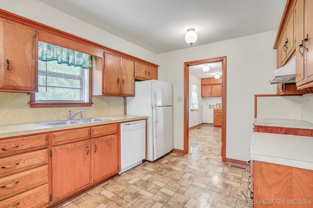 kitchen featuring white appliances and sink