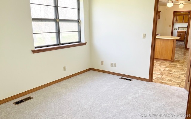 carpeted empty room with washer / dryer