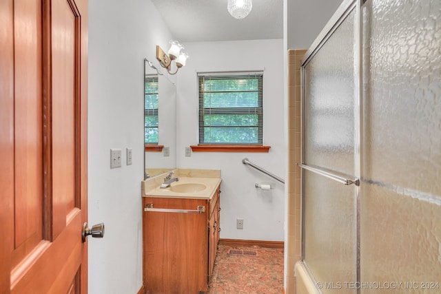 bathroom featuring vanity and a shower with door