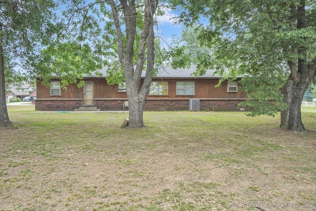 ranch-style house with a front lawn and central AC unit