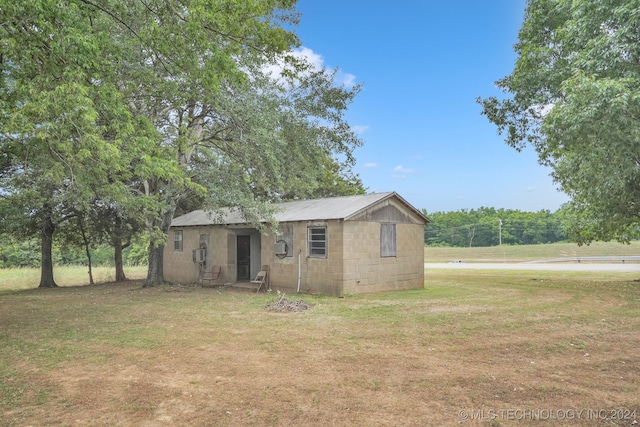 exterior space featuring a front yard and a storage shed