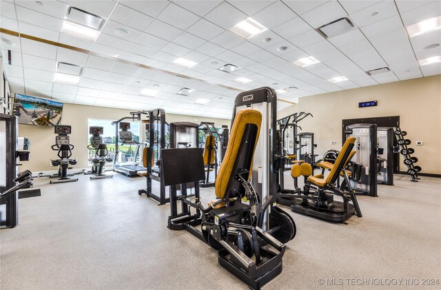 gym with a paneled ceiling