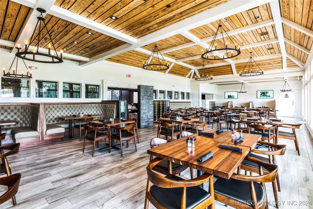 dining space featuring beamed ceiling, light hardwood / wood-style floors, wood ceiling, and high vaulted ceiling