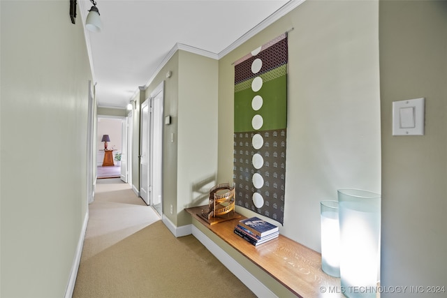 hall featuring crown molding and light carpet